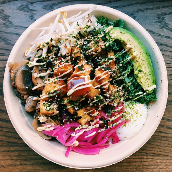 A Mighty Bowl with tofu, mushrooms, avocado, kale, bean sprouts, and pickled onions.